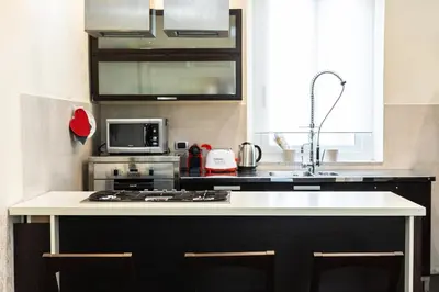a kitchen with a sink and a stove top oven at Nel Cuore di Testaccio by Rental in Rome in Rome