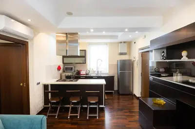 a kitchen with a table and some chairs in it at Nel Cuore di Testaccio by Rental in Rome in Rome