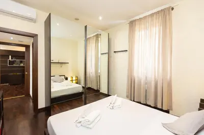 a hotel room with two beds and a mirror at Nel Cuore di Testaccio by Rental in Rome in Rome