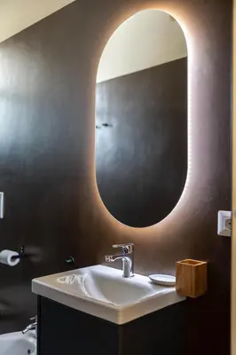 a bathroom with a sink and a large mirror at The Heartbeat of Bohemian Rome in Rome