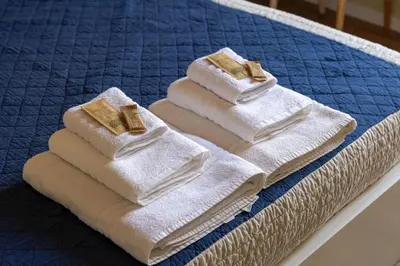 two towels sitting on top of a bed at The Heartbeat of Bohemian Rome in Rome