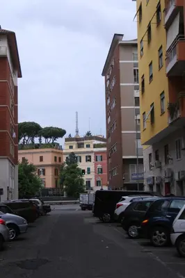 a parking lot with cars parked in front of buildings at Vatican Giulia in Rome