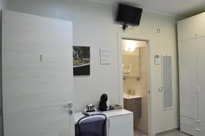 a bathroom with a toilet and a tv on the wall at Vatican Giulia in Rome