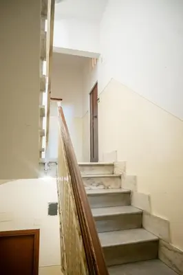 a staircase in a building with a stair railing at Yellow Pop Apartment - Design e Colore a Roma in Rome
