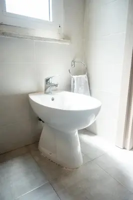 a white sink in a bathroom with a window at Yellow Pop Apartment - Design e Colore a Roma in Rome