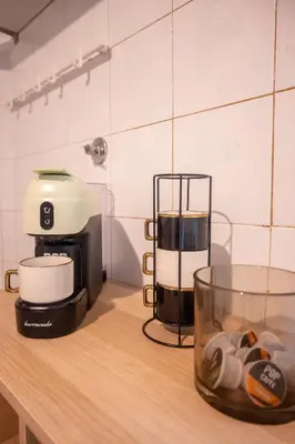 a counter top with a coffee maker and a glass cup at Yellow Pop Apartment - Design e Colore a Roma in Rome