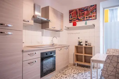 a kitchen with a sink and a stove at Yellow Pop Apartment - Design e Colore a Roma in Rome