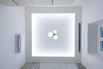 a white room with two lights on the wall at Casa Gemma Rome in Rome