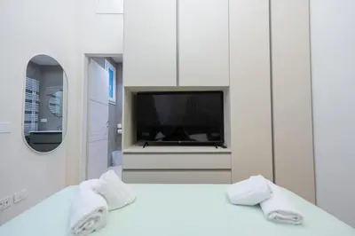 a white room with a tv in a white wall at Casa Gemma Rome in Rome