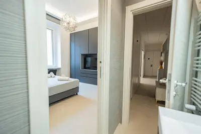 a bathroom with a bed and a television in a room at Casa Gemma Rome in Rome