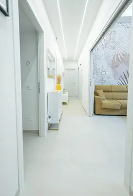 a white hallway with a couch in a room at Casa Gemma Rome in Rome