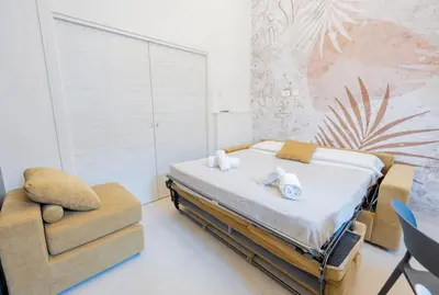 a bedroom with a bed and a chair at Casa Gemma Rome in Rome
