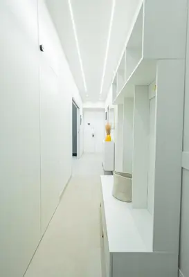 a white hallway with white cabinets and white floors at Casa Gemma Rome in Rome
