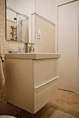 a white bathroom with a sink and a mirror at St Peter Vatican wonderfull view apartment in Rome