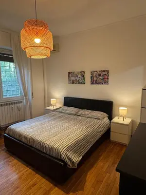 a bedroom with a bed and a chandelier at Appia 101 Guest House in Rome