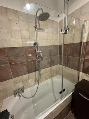 a bath tub with a shower with a glass door at Appia 101 Guest House in Rome