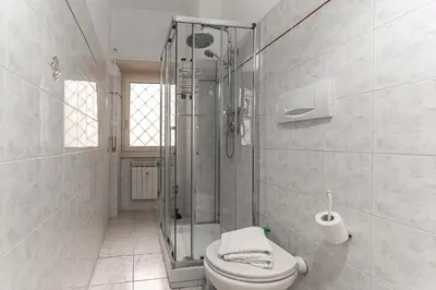 a bathroom with a shower and a toilet at Vacanze Romane - Metro Teano & Wi-Fi in Rome