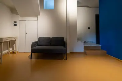 a living room with a couch and a blue wall at Livin' San Lorenzo in Rome