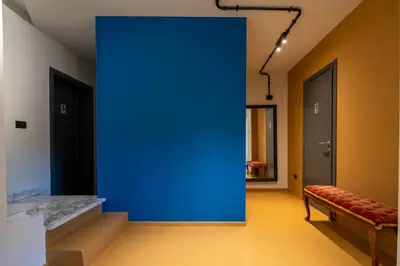 a blue wall in a hallway with a bench at Livin' San Lorenzo in Rome