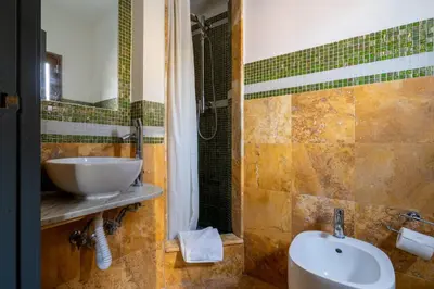 a bathroom with a sink and a toilet and a shower at Livin' San Lorenzo in Rome