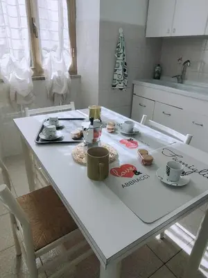a white table with cups and saucers on it at Rifugio del Quadraro Rome in Rome