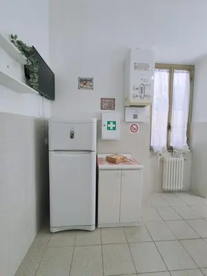 a kitchen with two white refrigerators in a room at Rifugio del Quadraro Rome in Rome