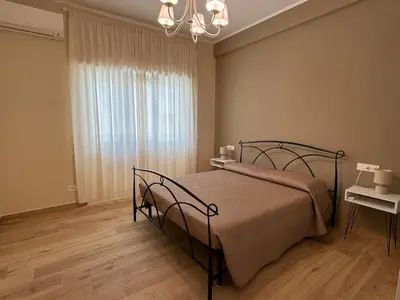 a bedroom with a bed and a chandelier at Living Aurelia - San Pietro in Rome