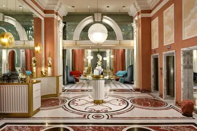 a lobby of a hotel with a table in the middle at Leon's Place Hotel In Rome in Rome