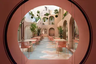 a room with tables and chairs and a mirror at Leon's Place Hotel In Rome in Rome