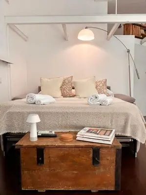a bedroom with a bed with a table with a lamp at Casa Mari Vaticano in Rome