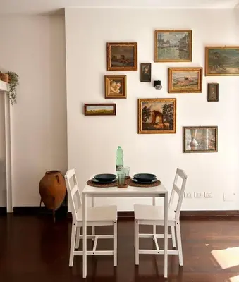 a white dining room with a white table and chairs at Casa Mari Vaticano in Rome