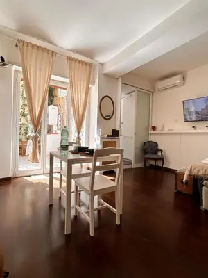 a living room with a table and chairs in it at Casa Mari Vaticano in Rome