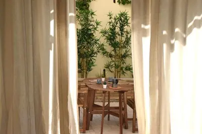 a dining room table with plants on the wall at Casa Mari Vaticano in Rome