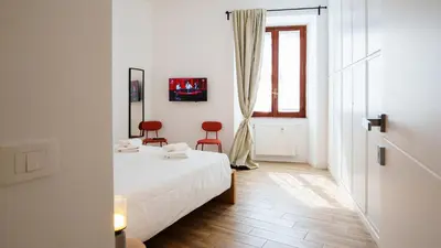 a living room with a table and a couch at Simi Roma Palombini, Appartamento con Giardino in Rome