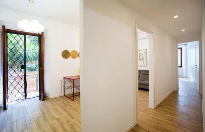 an empty room with white walls and wooden floors at Simi Roma Palombini, Appartamento con Giardino in Rome