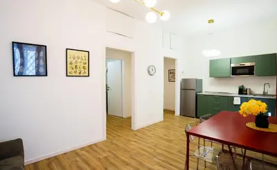 a bedroom with a large bed and a wooden floor at Simi Roma Palombini, Appartamento con Giardino in Rome