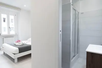 a bedroom with a bed and a glass shower at Domus Aurea2 a stone's throw from the Colosseum in Rome