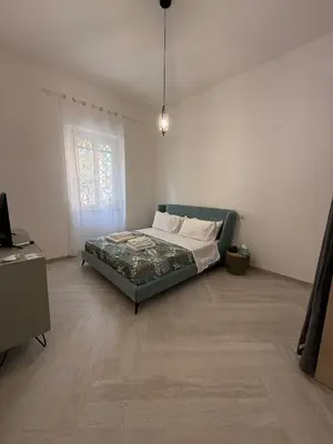 a bedroom with a bed in the corner of a room at Domus Battistini in Rome