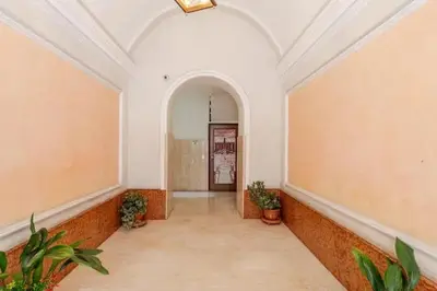 an empty hallway in a building with plants in it at Dante Art Home in Rome