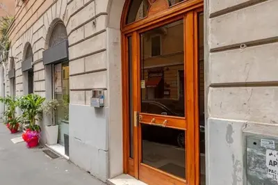 a wooden door to a store on a street at Dante Art Home in Rome