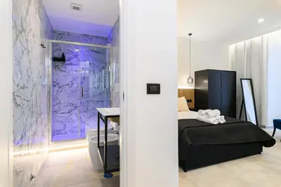 a bedroom with a bed and a purple wall at Vittorio Emanuele Art Suites in Rome
