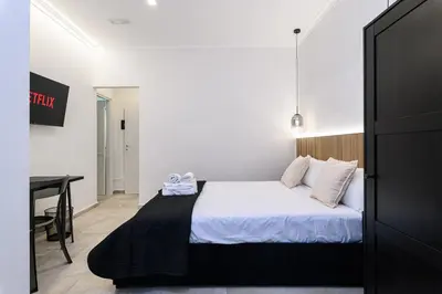 a bedroom with a bed and a desk in it at Vittorio Emanuele Art Suites in Rome
