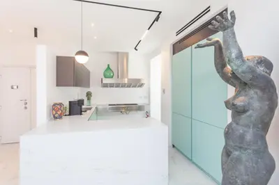 a kitchen with a statue of a woman on the wall at Arte della Medaglia Gallery House in Rome