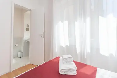 a room with a bed with white towels on it at Arte della Medaglia Gallery House in Rome