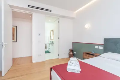 a bedroom with a bed with a red blanket at Arte della Medaglia Gallery House in Rome
