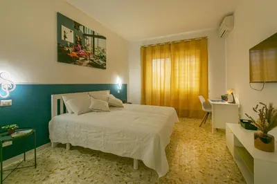 a bedroom with a bed and a table and a desk at Casa Leone in Rome