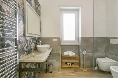 a bathroom with a sink and a tub and a toilet at Casa Leone in Rome