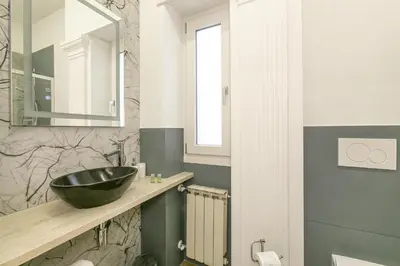 a bathroom with a black sink and a mirror at Casa Leone in Rome