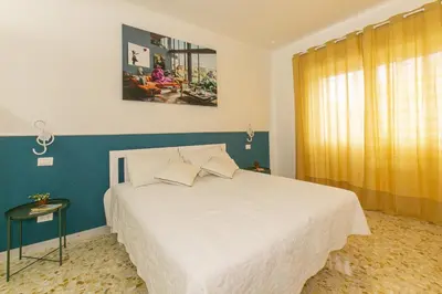 a bedroom with a large white bed and a window at Casa Leone in Rome