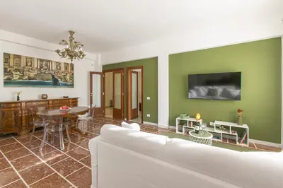 a living room with a white couch and a table at Casa Leone in Rome